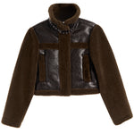 A cropped brown jacket featuring a dark brown faux-leather body with matching brown faux-shearling sleeves, collar, and trim, accented by silver studs on the collar.