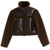 A cropped brown jacket featuring a dark brown faux-leather body with matching brown faux-shearling sleeves, collar, and trim, accented by silver studs on the collar.