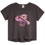 A vintage black short-sleeve t-shirt featuring a graphic print of pink lipstick and lipstick kiss marks on the front, displayed against a solid white background.