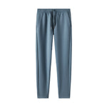 A pair of men's lounge pants in a dusty slate blue color, featuring an elastic waistband with a matching drawstring and side pockets, shown against a plain white background.