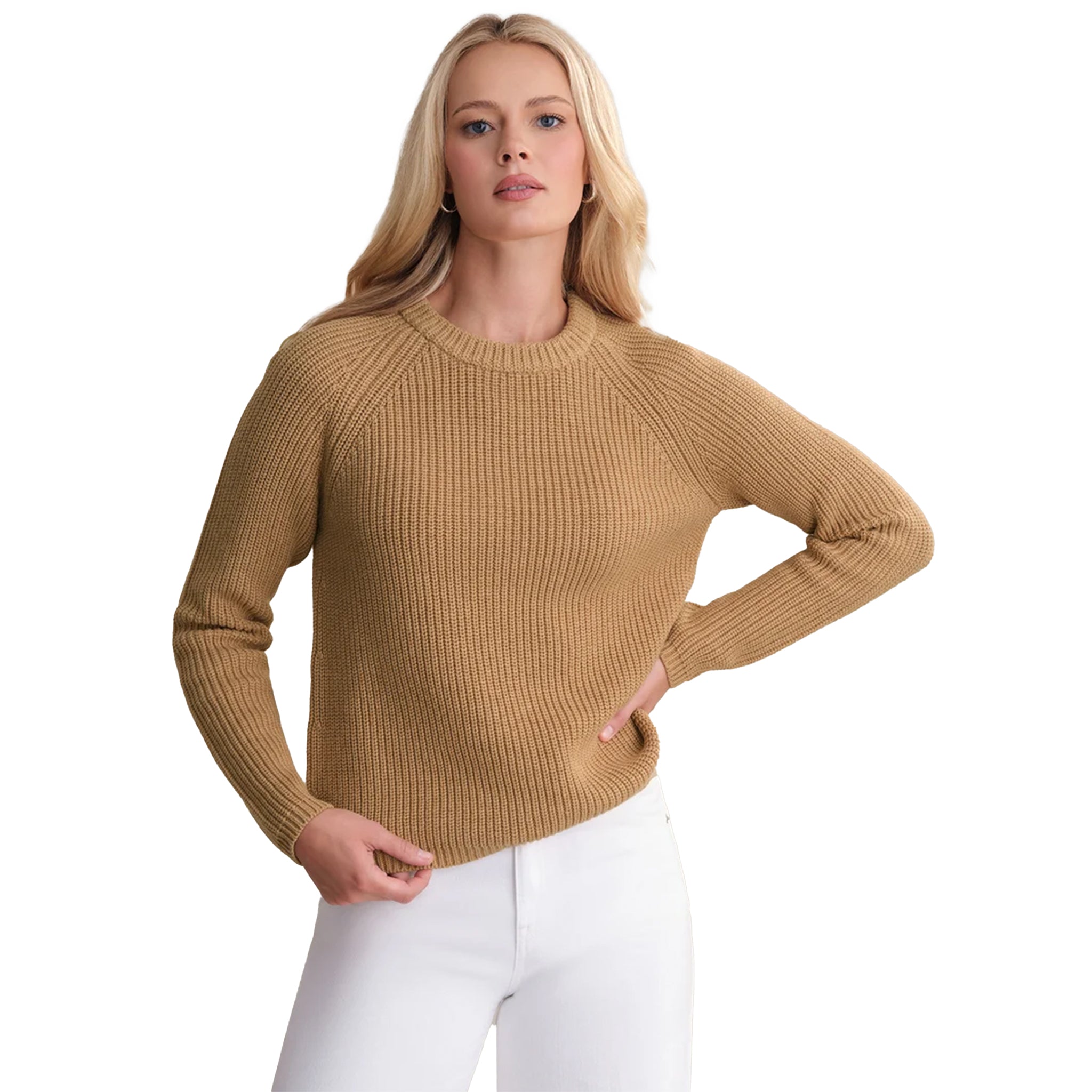 A woman modeling a ribbed knit long-sleeve sweater in camel tan, paired with white pants, against a plain white background.