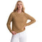 A woman modeling a ribbed knit long-sleeve sweater in camel tan, paired with white pants, against a plain white background.