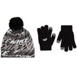 A Nike winter accessory set featuring a gray and black patterned beanie with a black pom-pom, a pair of black knit gloves with gray fingertips, and a white Nike logo on the beanie and one glove.