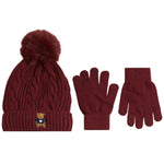 A winter accessory set featuring a cable-knit beanie with a fluffy pom-pom, a pair of matching knit gloves, and a small embroidered teddy bear logo on the beanie cuff, shown on a plain white background.