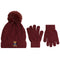 A winter accessory set featuring a cable-knit beanie with a fluffy pom-pom, a pair of matching knit gloves, and a small embroidered teddy bear logo on the beanie cuff, shown on a plain white background.