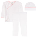 A three-piece baby clothing set including a white long-sleeve wrap top with light pink trim, white leggings, and a white beanie with a pink scalloped edge, displayed on a solid white background.