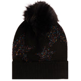 A black knit beanie hat featuring a large black faux fur pom-pom on top and iridescent star pattern knitted all over the front, shown against a plain white background.