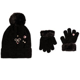 A black knit beanie with a fluffy pom-pom and decorative rhinestone bow embellishments, shown alongside matching black gloves with faux-fur trim on a plain white background.