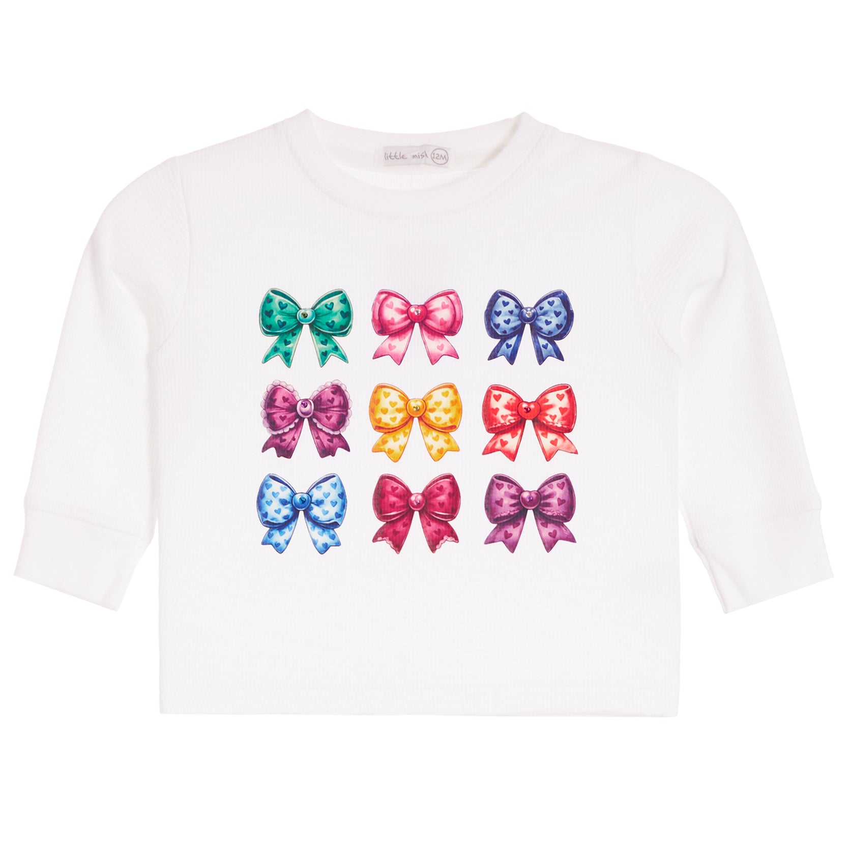 A white long-sleeve t-shirt for toddlers, featuring a graphic print of nine colorful glittery bows arranged in a 3x3 grid on the front.