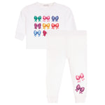 A children's two-piece set featuring a white long-sleeve top and matching white pants. The top is decorated with a grid of colorful embroidered bows in green, pink, blue, purple, and orange.