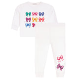 A children's two-piece set featuring a white long-sleeve top and matching white pants. The top is decorated with a grid of colorful embroidered bows in green, pink, blue, purple, and orange.