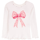 A white long-sleeve top with a large pink floral bow graphic on the front, small rhinestone embellishments around the neckline, and ruffled trim at the hem.