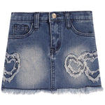 A blue denim mini skirt with a frayed hem, featuring distressed heart-shaped patches embellished with rhinestones on the front left and right sides.