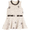 A sleeveless cream-colored tweed dress with black embroidered details, including horizontal stripes, rose motifs, and a decorative waistband.