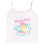 A white spaghetti-strap camisole tank top featuring a retro-style tropical graphic with palm trees, a pink and yellow sunset, and the text 'the good life' in pink script across the chest.