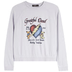 A white long-sleeve crewneck sweatshirt featuring a colorful graphic print on the front. The graphic is inspired by the Grateful Dead, showing a cracked red and blue heart with a yellow lightning bolt, two teddy bears, and text reading 'Grateful Dead', 'July 15-71', '1988', and 'Live at the Great Bear Lake, Berkeley, California'.