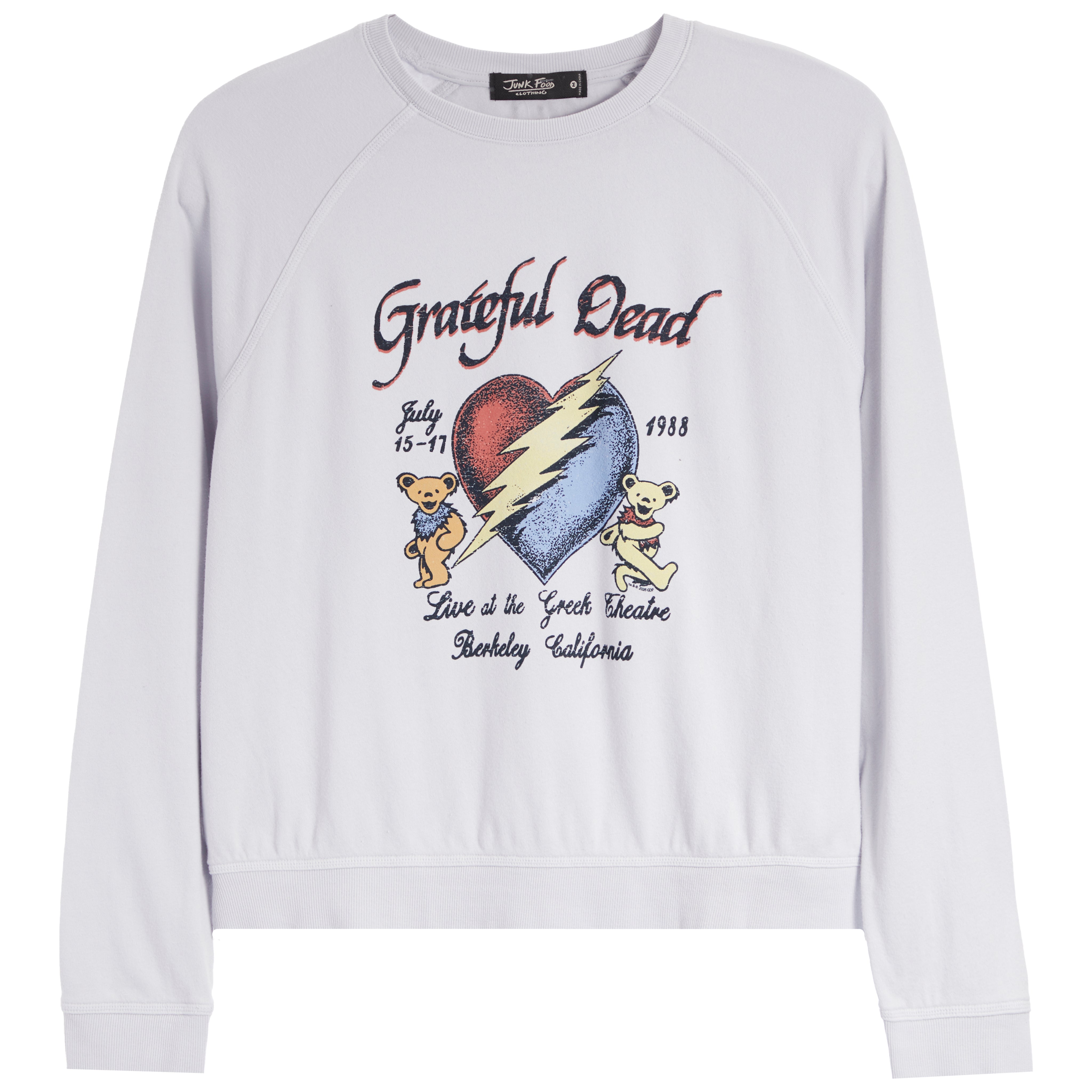 A white long-sleeve crewneck sweatshirt featuring a colorful graphic print on the front. The graphic is inspired by the Grateful Dead, showing a cracked red and blue heart with a yellow lightning bolt, two teddy bears, and text reading 'Grateful Dead', 'July 15-71', '1988', and 'Live at the Great Bear Lake, Berkeley, California'.