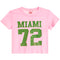 A pink short-sleeve crop top t-shirt featuring a distressed green graphic print that reads 'MIAMI 72' on the front, displayed against a solid white background.