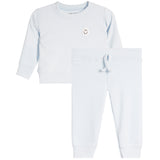 A baby or toddler two-piece loungewear set in light blue, featuring a long-sleeve sweatshirt with a small embroidered smiley face on the chest and matching jogger pants with a drawstring waist.