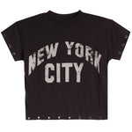 A charcoal short-sleeve crop top T-shirt featuring a distressed white arched 'NEW YORK CITY' graphic on the front, with metal eyelet details along the sleeve cuffs and hem.