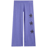Purple wide-leg sweatpants featuring three drippy star motifs outlined in black on the right leg, displayed against a solid white background.