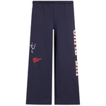 Navy blue wide-leg sweatpants featuring a white graphic on the left thigh, a small red flag patch, and vertical 'GAME DAY' text on the right leg, shown against a plain white background.