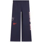 Navy blue wide-leg sweatpants featuring a white graphic on the left thigh, a small red flag patch, and vertical 'GAME DAY' text on the right leg, shown against a plain white background.