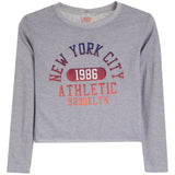 A heather gray long-sleeve crop top featuring a distressed graphic print on the front with the text 'NEW YORK CITY 1986 ATHLETIC BROOKLYN' in navy and coral colors.