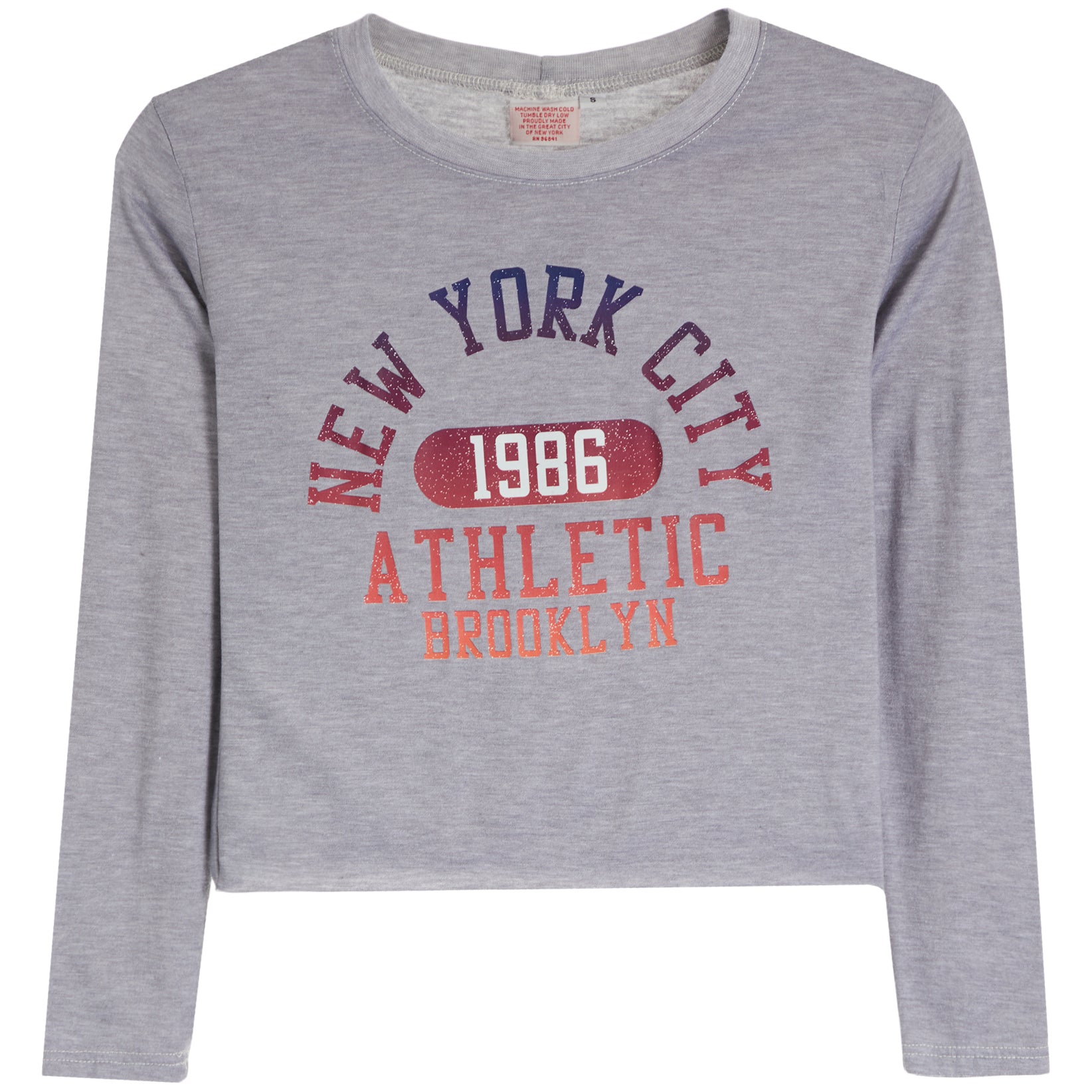 A heather gray long-sleeve crop top featuring a distressed graphic print on the front with the text 'NEW YORK CITY 1986 ATHLETIC BROOKLYN' in navy and coral colors.