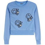 A light blue crewneck sweatshirt featuring three cartoon smiley face graphics with hearts on the front, displayed on a clean white background.