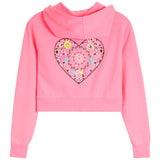 A pink cropped hoodie sweatshirt with a long hood and a large, featuring a decorative heart-shaped applique on the back with bandana print and a yellow sun and rainbow, shown against a plain white background.