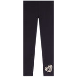 Black leggings with a textured, glittery silver heart design on the lower left leg, displayed flat against a solid white background.