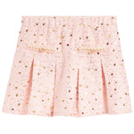 A light pink pleated skirt covered in gold sequins, featuring decorative gold embroidered details on the front.