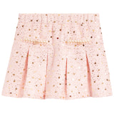 A light pink pleated skirt covered in gold sequins, featuring decorative gold embroidered details on the front.