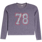 A kids' long-sleeve crop top in heathered periwinkle purple, featuring a large '78' graphic on the chest with a blue paisley pattern and a red outline.