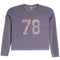 A kids' long-sleeve crop top in heathered periwinkle purple, featuring a large '78' graphic on the chest with a blue paisley pattern and a red outline.
