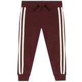 A pair of dark burgundy jogger pants featuring two vertical cream-colored stripes down the sides of each leg, a matching dark burgundy drawstring waist, and ribbed cuffs at the ankles.