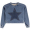 A cropped blue denim sweatshirt featuring a large dark blue star patch on the front, embellished with small gold-tone studs, shown against a plain white background.