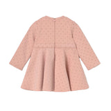A light pink long-sleeve dress with a subtle polka dot pattern, shown from the back on a solid white background.