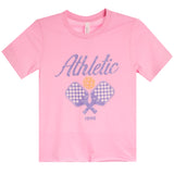 A pink short-sleeve t-shirt with a graphic on the front featuring the word 'Athletic' in purple script, two crossed tennis rackets with a checkerboard pattern, a yellow tennis ball, and the year '1990' printed below.