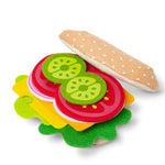 Colorful toy hamburger with pickle slices on a white background