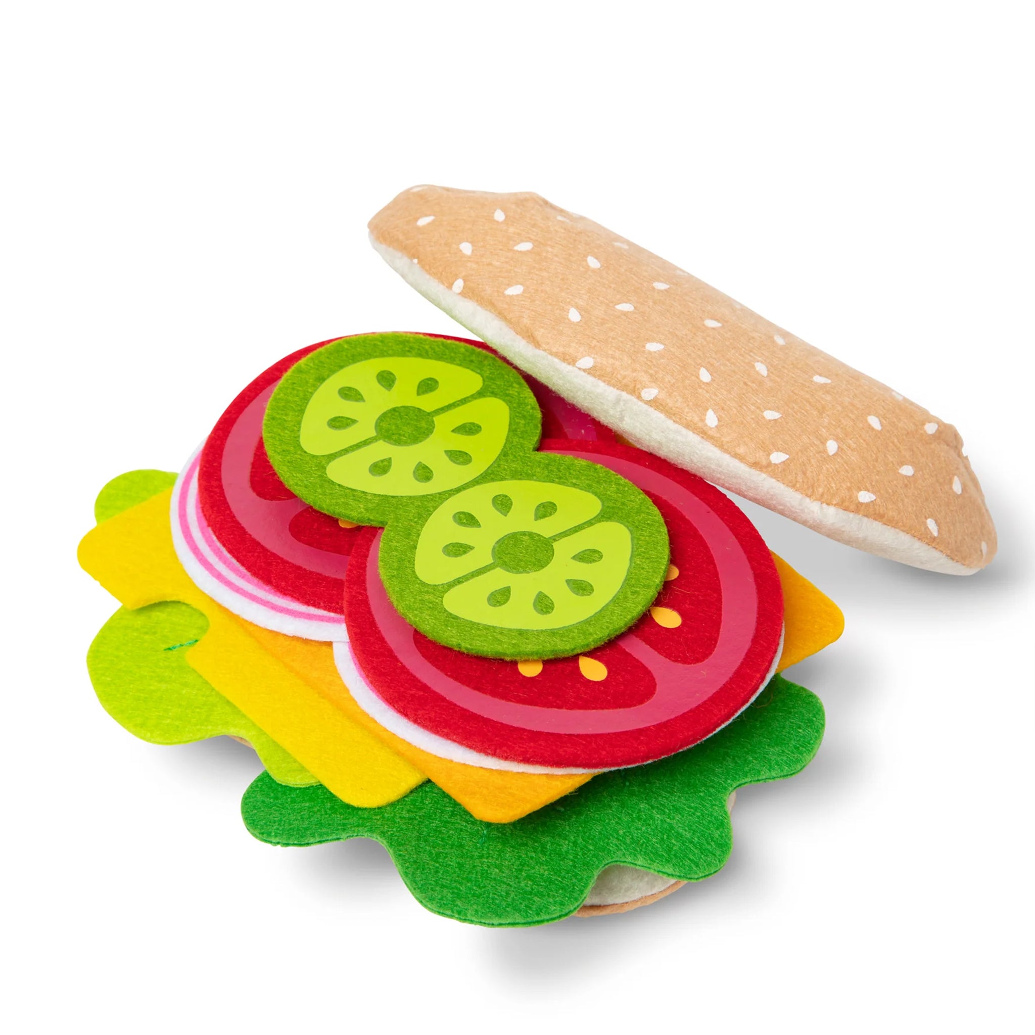 Colorful toy hamburger with pickle slices on a white background