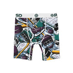 Men's boxer briefs featuring an all-over hockey-themed graphic print with skates, hockey sticks, helmets, pucks, and a teal star logo. The waistband is white with green 'PSD' lettering.