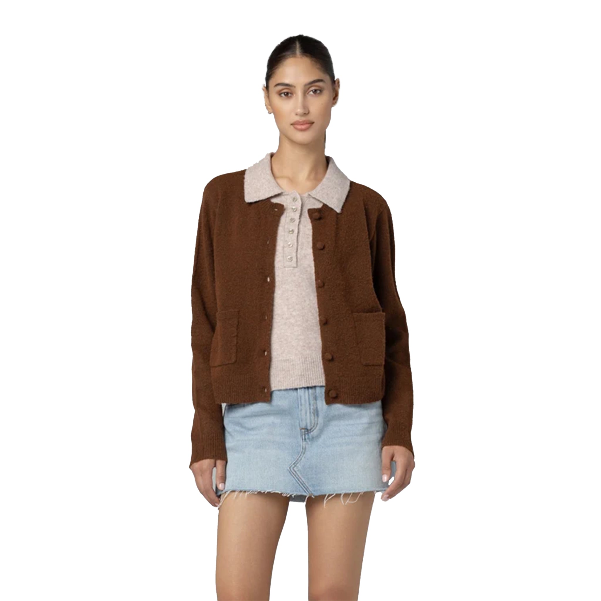 A woman modeling a brown button-up cardigan with a light beige knit collar, layered over a beige knit top and a light blue denim mini skirt, against a plain white background.