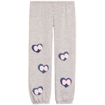 Light heather gray jogger pants with four heart-shaped patches on the legs, each featuring a pink bow on a navy blue background.