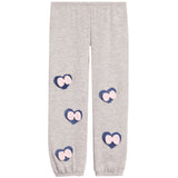 Light heather gray jogger pants with four heart-shaped patches on the legs, each featuring a pink bow on a navy blue background.