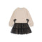 A children's long-sleeve dress with a cream-colored knit top and a black tiered tulle skirt with small bow details, shown on a plain white background.