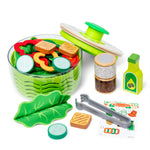 Toy salad set with various components on a white background