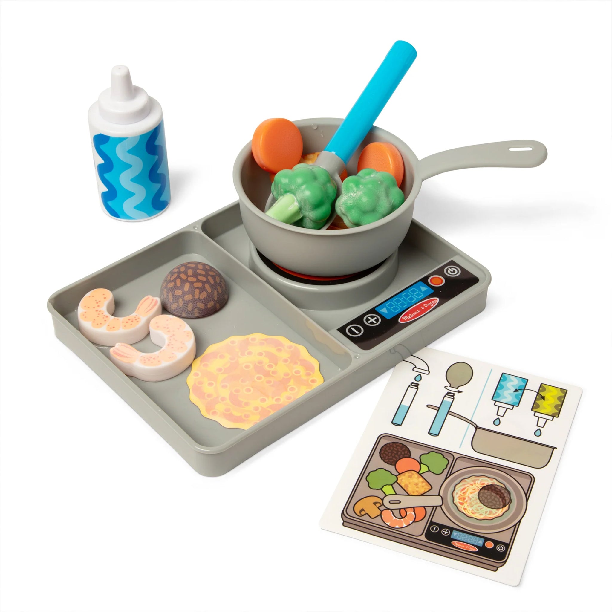 Toy kitchen set with pan, tray, and toy food items on a white background