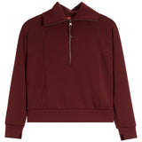 Spanx dark burgundy long-sleeve quarter-zip sweatshirt with a stand-up collar and zippered chest, displayed on a clean white background.